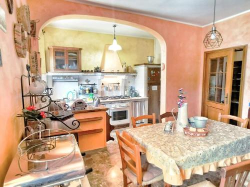 a kitchen with a table and chairs and a table and a table and a kitchen at B&B Santa Vittoria in Monteleone Sabino