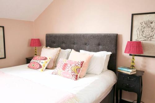 a bedroom with a bed with pillows and two lamps at The View in Bowness-on-Windermere