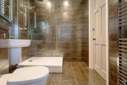 a bathroom with a toilet and a sink and a shower at The View in Bowness-on-Windermere