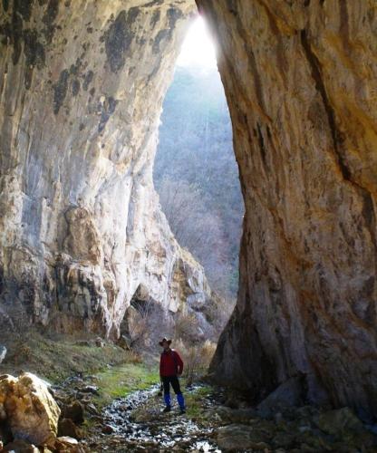 a man standing inside of a cave at Miliceva ruza in Zlatibor