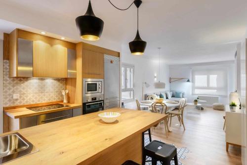 a kitchen with a wooden table and a dining room at Casa Oso in Panticosa