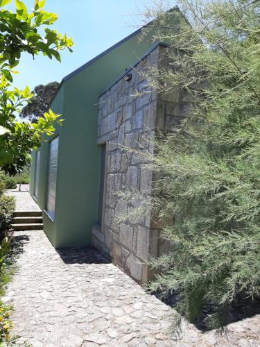 a stone wall with a door on a building at Casa do Eido dos Calhões in Ponte de Lima