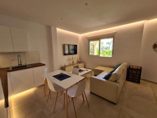 a living room with a couch and a table with chairs at Apartamento Puerto Marina Beach in La Carihuela