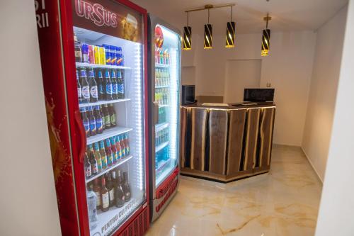 a refrigerator filled with lots of bottles of soda at Hotel Proton in Neptun