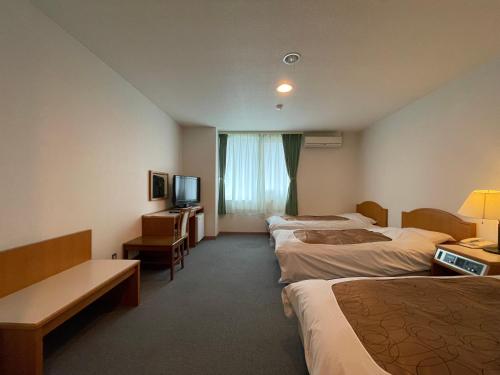 Postel nebo postele na pokoji v ubytování Hotel Ginsui