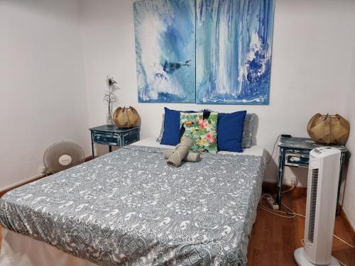 a bedroom with a bed with a teddy bear on it at The Portuguese Element in Faro