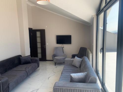 a living room with a couch and two chairs at Royal Residence Bursa in Bursa