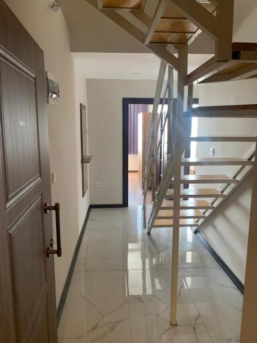 a hallway with a staircase in a house at Royal Residence Bursa in Bursa
