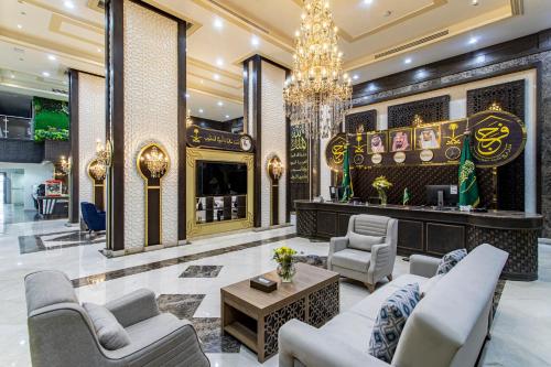 a lobby with couches and chairs and a chandelier at Faraj Almadina Hotel in Al Madinah