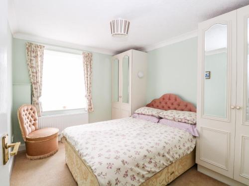 a small bedroom with a bed and a window at Ellan Vannin in Sheringham