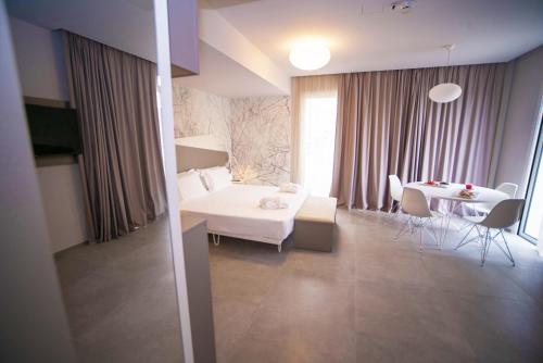 a living room with a white couch and a table at Hotel Malavoglia in Acitrezza