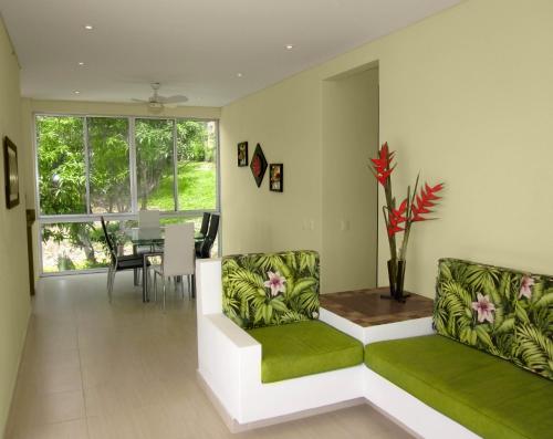 a living room with two couches and a table at Natura Reservado - Hoteles Natura in Anapoima