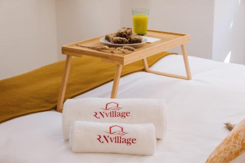 a small table with a plate of food and a glass of orange juice at Casa da Tia Zézinha by RNvillage in Sesimbra