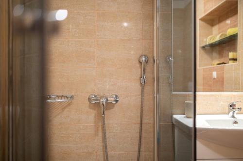 a bathroom with a shower and a sink at Apartments Tonica in Malinska