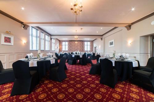 a large room with tables, chairs, and tables in it at Quality Hotel Coventry in Coventry