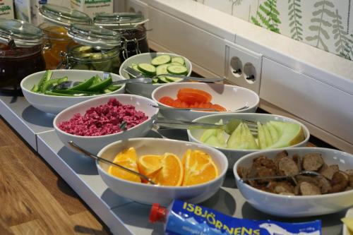 a buffet with bowls of different types of vegetables at Best Western Uppsala in Uppsala