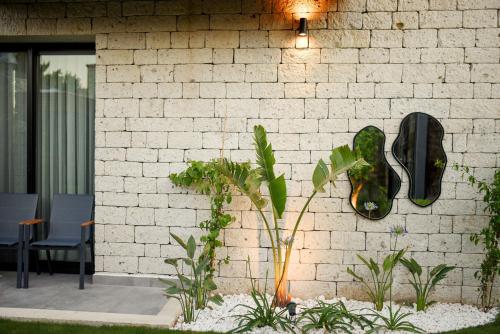 a brick wall with a pair of shoes on it at Enso Alaçatı in Cesme