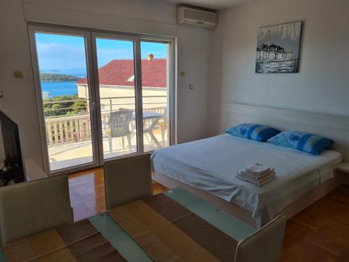 a bedroom with a bed and a view of a balcony at Villa Luciana in Trogir