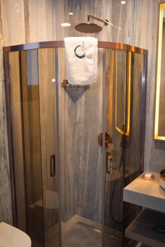 a shower with a glass door in a bathroom at Enso Alaçatı in Cesme