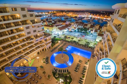 an aerial view of a city at night with buildings at Vila Gale Marina in Vilamoura