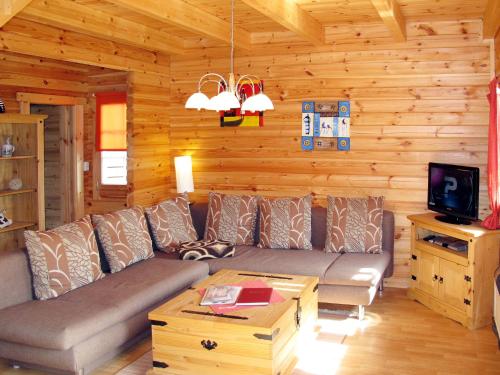 a living room with a couch and a tv at Holiday Home Zum Stolpseefischer by Interhome in Himmelpfort