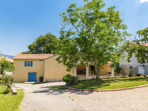 a house with a tree and a driveway at Holiday Home Mariva by Interhome in Potpićan