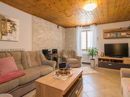 a living room with a couch and a tv at Holiday Home Mariva by Interhome in Potpićan