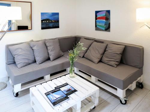 a living room with a couch and a table at Holiday Home Les maisons de la forêt by Interhome in Lacanau-Océan