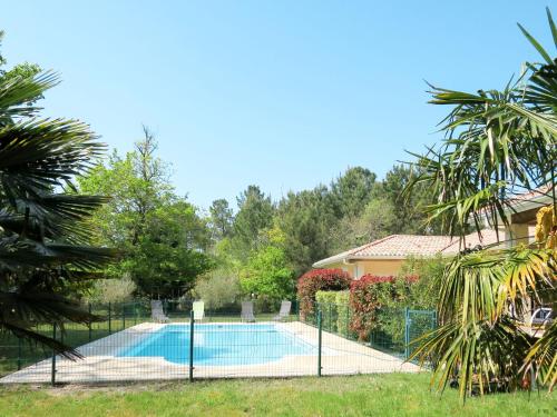 a swimming pool in the backyard of a house at Holiday Home Eugénie - GHP190 by Interhome in Grayan-et-lʼHôpital