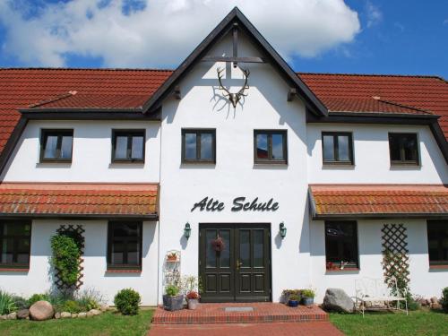 a white building with a red roof at Apartment Rügen by Interhome in Dargun