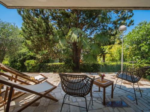 a patio with two chairs and a table at Holiday Home Vesna by Interhome in Njivice