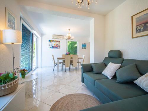 a living room with a couch and a table at Holiday Home Vesna by Interhome in Njivice