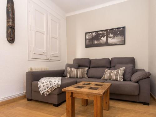 a living room with a couch and a coffee table at Apartment Sagrada Familia Grassot - Industria by Interhome in Barcelona