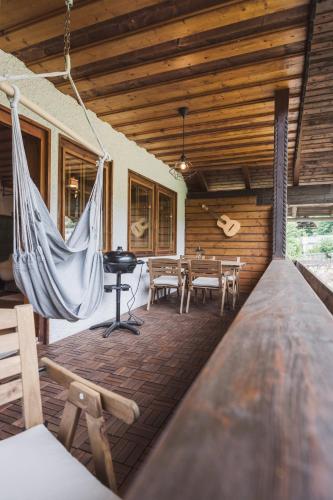 a porch with a hammock in a house at Ferienwohnungen Villa Salzweg in Bad Goisern