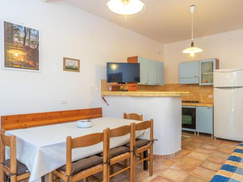 a kitchen and dining room with a table and chairs at Apartment Villa Katia by Interhome in La Ciaccia