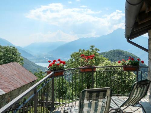 a balcony with chairs and a view of the mountains at Holiday Home Baita dei Nonni-3 by Interhome in Livo