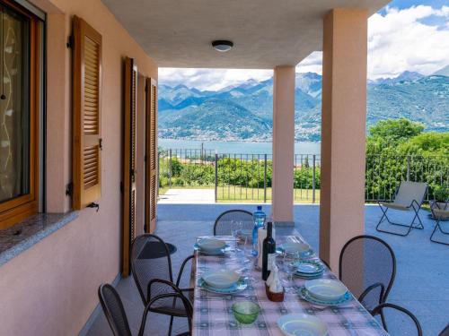 a table on a balcony with a view of the mountains at Holiday Home La Casetta - CCO107 by Interhome in Colico