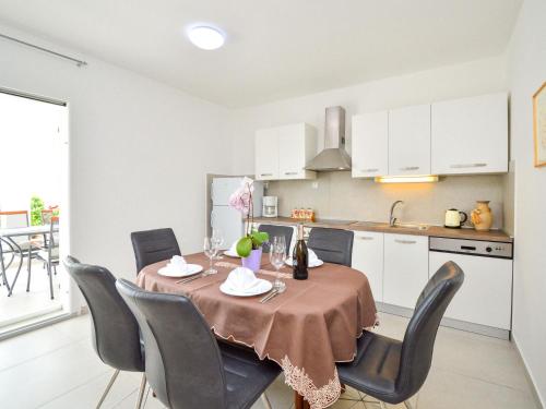 a kitchen and dining room with a table and chairs at Holiday Home Tramontana by Interhome in Sovlje