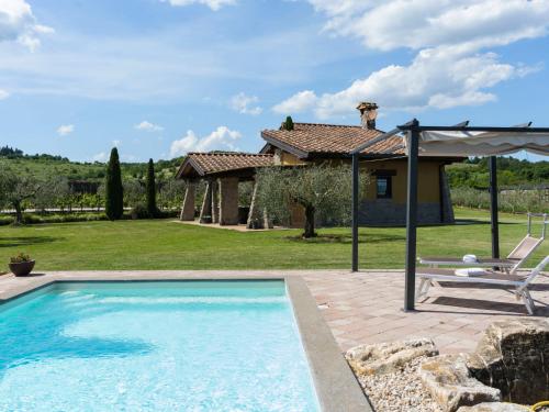 a pool in front of a house with a patio at Villa Cipresso by Interhome in Sutri