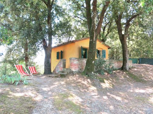 a couple of chairs sitting in front of a house at Holiday Home Casottino - PAA131 by Interhome in Palaia