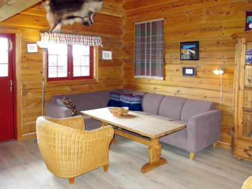 a living room with a couch and a table at Holiday Home Kvila by Interhome in Øyuvstad