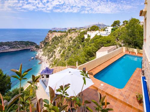 a villa with a swimming pool and a view of the ocean at Holiday Home Igor by Interhome in Balcon del Mar