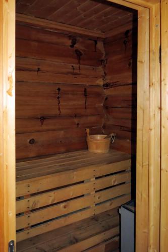 a room with a wooden wall with a bucket in it at Holiday Home Kvila by Interhome in Øyuvstad