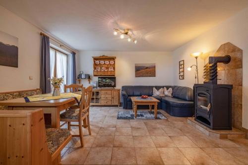 a living room with a couch and a wood stove at Stembergerhof - Urlaub am Bauerhof in Liesing