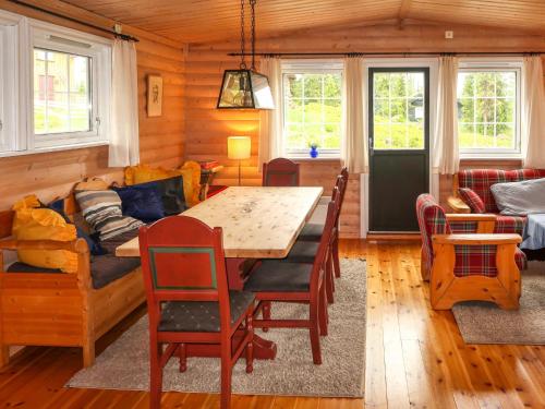 a living room with a wooden table and a couch at Chalet Liaråket - OPP209 by Interhome in Svingvoll