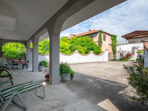 an outdoor patio with chairs and a white fence at Holiday Home Casa della Peschiera by Interhome in Isola d'Asti