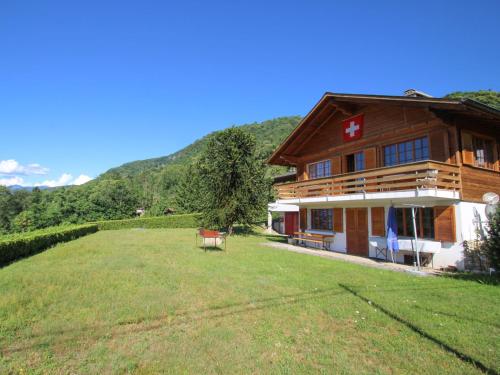 a large building with a grass field in front of it at Chalet Gallina by Interhome in Castelveccana