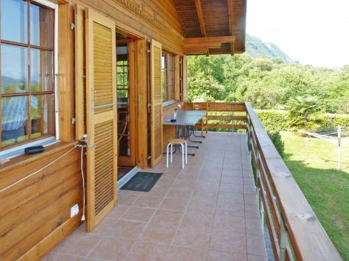 a porch of a house with a table and chairs at Chalet Gallina by Interhome in Castelveccana