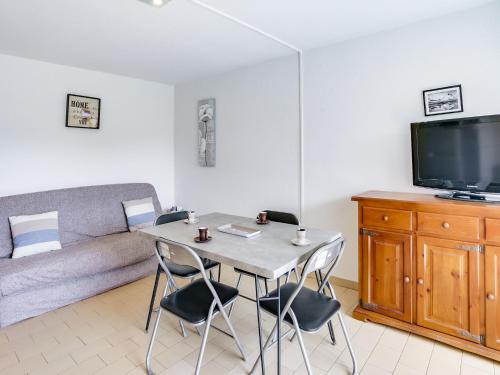 a living room with a table and chairs and a couch at Apartment Les Frégates by Interhome in Saint-Cyprien-Plage