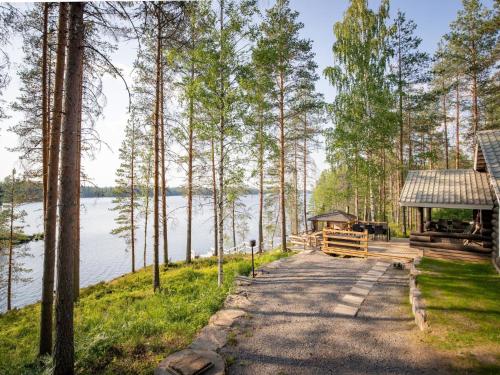 a dock with a gazebo next to a lake at Holiday Home Kalliomökki by Interhome in Huuhanaho